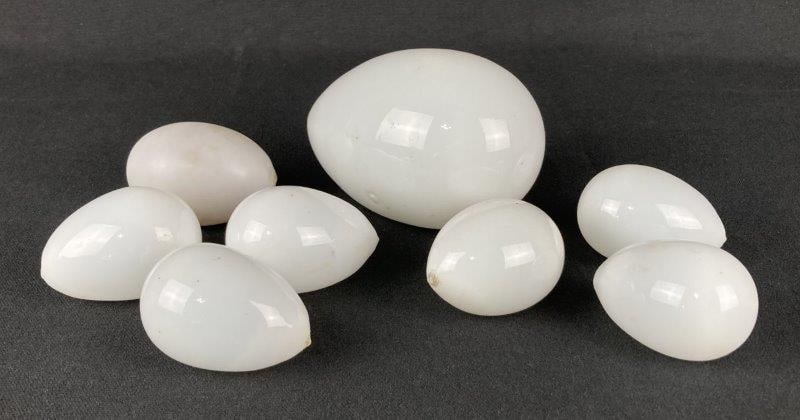 Blown Glass Eggs: Elegant grouping of blown opaque milk-glass eggs, each displaying smooth contours and refined hand-crafted form. Largest measures approximately 5" H x 3" in diameter. Overall in good condition with mi