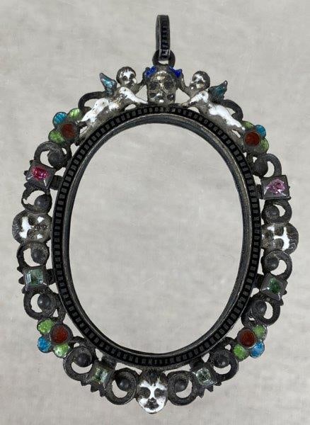 Memento Mori Mourning Locket Frame, 19th Century: 19th-century mourning jewelry Memento Mori locket frame pendant featuring symbolic imagery honoring remembrance and mortality, including skull motifs throughout and cherubs at the top, complemented by