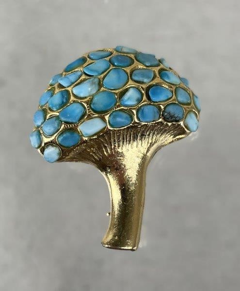 Vintage Swoboda Mushroom Brooch: Charming vintage Swoboda mushroom brooch crafted in goldtone metal, featuring small turquoise stones set into the cap. Stamped SWO. Inc on the reverse. Measures approx. 1 1/4" H x 1 1/8" W. In good co