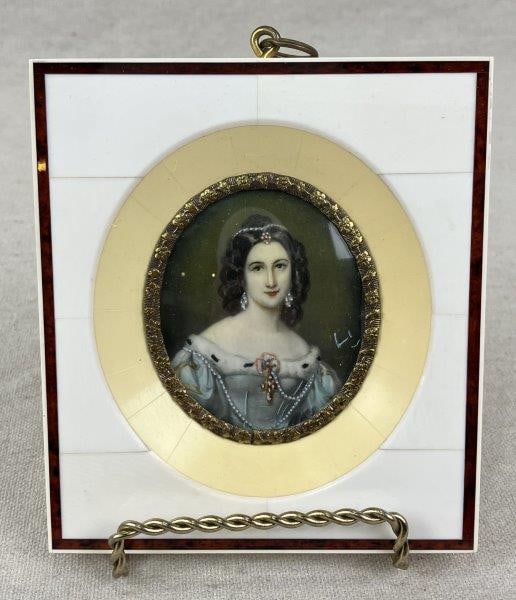 German Miniature Portrait: German miniature portrait of Charlotte von Hagn presented in an inlaid bone frame decorated with a floral motif and accented by a gilt border surrounding the portrait. Measures approx. 4 3/4" H x 4 1/