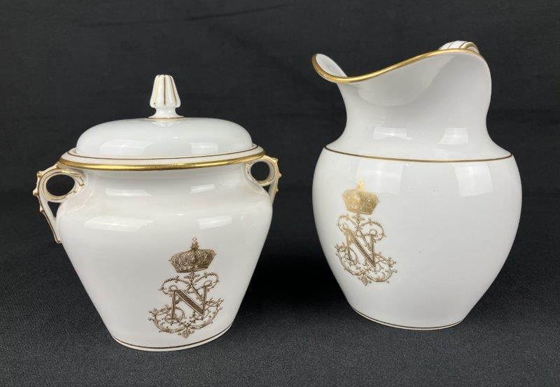 Sèvres Napoleon III Porcelain Creamer and Sugar: A mid-19th-century Sèvres porcelain creamer and covered sugar bowl produced during the Napoleon III period, decorated with fine gilt detailing and Napoleonic emblems. The set reflects high-qualit