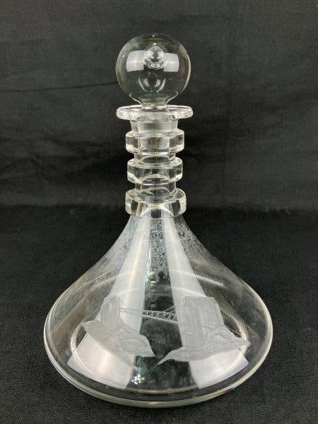 Steuben Etched Glass “Ship’s Decanter”: A Mid-Century Modern etched glass decanter by Steuben Glass, designed by Donald Pollard in the 1950s. Unsigned. The decanter features the distinctive neck with four graduated rings and a spherical sto