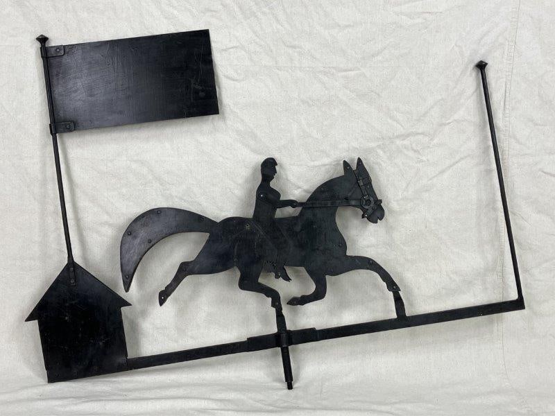 Horse and Rider Weathervane: A weathervane formed as the silhouette of a horse and rider, the figure detailed with bridled horse and riderâ€™s boots fitted with spurs. Measures approximately 33" H x 44 1/6" W. Sh