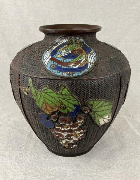 Large Japanese Enamel and Bronze Vase: A high-quality Japanese vase combining enameled decoration with detailed bronze work, featuring grape motifs and dragon medallion designs. The richly textured surface and sculptural bronze elements re