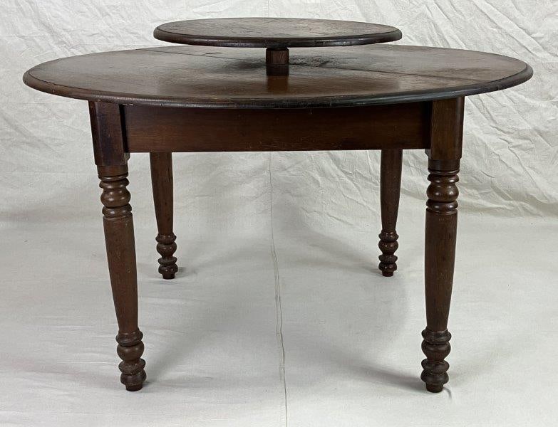 19th Century Lazy Susan Walnut Table: Expertly crafted with finely turned legs and a rich dark wood patina, this Lazy Susan table displays classic proportions and skilled workmanship. Measures approximately 34" H x 47" in diameter. Shows