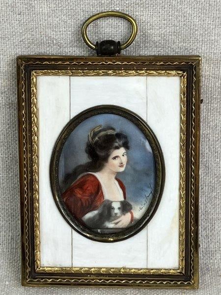 Lady Hamilton Painted Miniature of Woman and Dog: A painted portrait miniature after George Romney’s Lady Hamilton with Her Spaniel, depicting a woman accompanied by a dog rendered with precise, careful brushstrokes. Signed by the artist. House