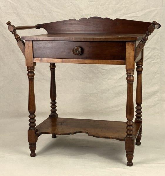 Willson & Robisons American Walnut Washstand: A well-crafted American walnut washstand featuring turned legs, towel bars, a shaped backsplash, and a shaped apron, displaying classic proportions and warm wood tones. Measures approximately 32" H x