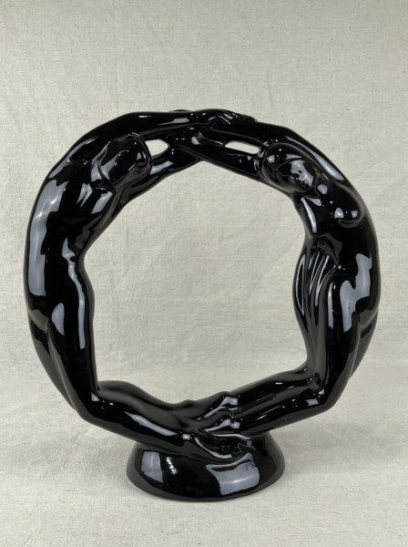 Royal Haeger “Circle of Love” Art Pottery Sculpture: A Royal Haeger art pottery sculpture in the “Circle of Love” design, also known as the Eternity or Connection form, finished in a glossy black glaze with flowing modern contours. Measures