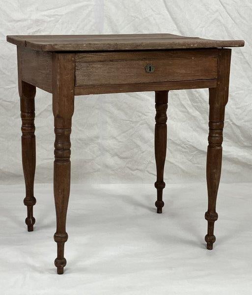 One-Drawer Stand: Featuring turned legs and a brass lock, this one-drawer stand displays a traditional form with practical storage and pleasing proportions. Measures approximately 30" H x 27" W x 21 1/2" D. Shows gener