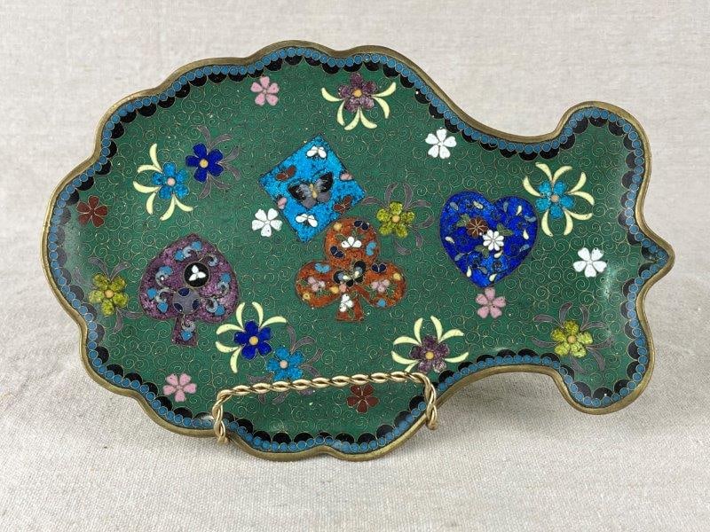Cloisonné Fish-Form Tray: A cloisonné tray modeled in the form of a fish, featuring a green enamel ground decorated with colorful butterflies and floral motifs. The piece displays lively enamel work and whimsical form. Me