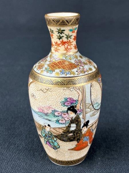Miniature Japanese Satsuma Cabinet Vase: A Meiji-era Japanese Satsuma cabinet vase, decorated with gilt accents and finely detailed narrative figural scenes, interspersed with floral and geometric designs. Displays the characteristic surface