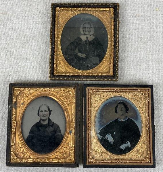 Three 19th-Century Ambrotype Photographs: A group of three 19th-century ambrotype photographs depicting beautiful ladies in period attire. Each image is housed in an embossed frame with brass preservers, displaying the refined presentation ty