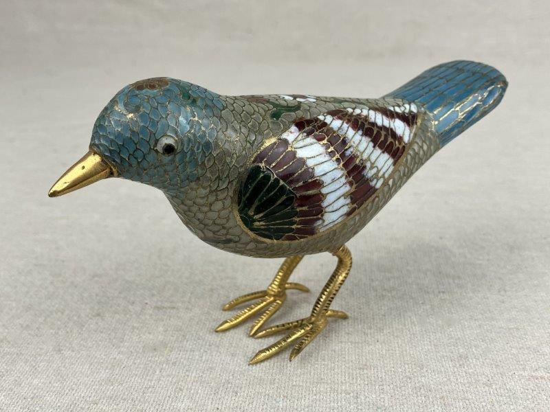 Chinese Cloisonné Bird Figurine: A Chinese cloisonné bird figurine richly enameled with floral details, displaying vibrant color and finely executed enamel work. The figure is modeled with graceful proportions and decorative sur