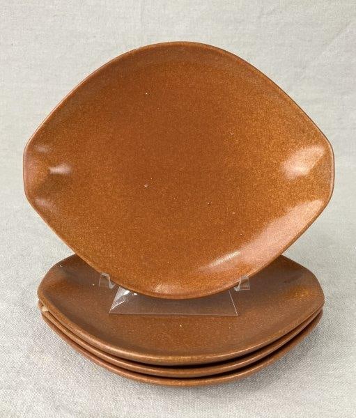 Four Ben Seibel Raymor Roseville Plates: A set of four plates designed by Ben Seibel for Raymor, produced by Roseville Pottery. Finished in a rich terracotta glaze, the plates display Seibel’s organic, streamlined mid-century modern fo
