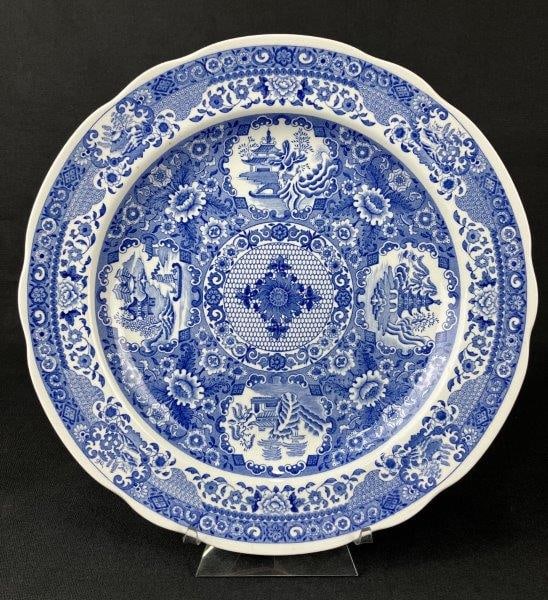 Blue and White Spode Chinoiserie Plate: A blue and white plate by Spode, decorated with a net-pattern border and a central Chinoiserie-style design. Bears the maker’s mark to the underside. Measures approximately 1″ H x 10 1/4&#