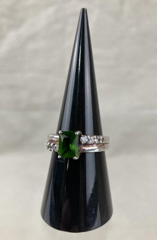 Sterling Silver Chrome Diopside Ring: Sterling silver ring featuring a rectangular-cut lime green chrome diopside set in a clean, modern mount, complemented by a split-shank band accented with six small cubic zirconia stones for added spa