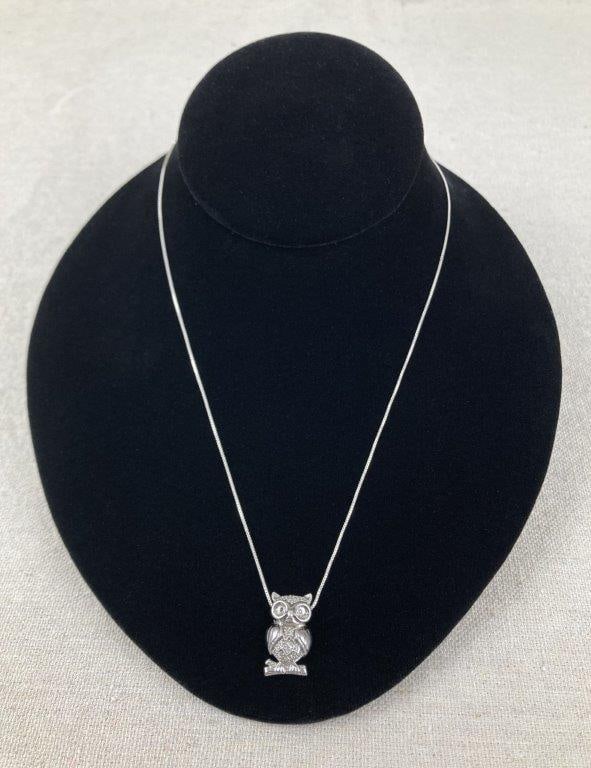 Sterling Silver Owl Necklace: Sterling silver owl pendant necklace featuring small black stones set in the eyes and the body accented with clear rhinestones for added sparkle. Stamped 925 AJ and suspended from an 18" box chain.