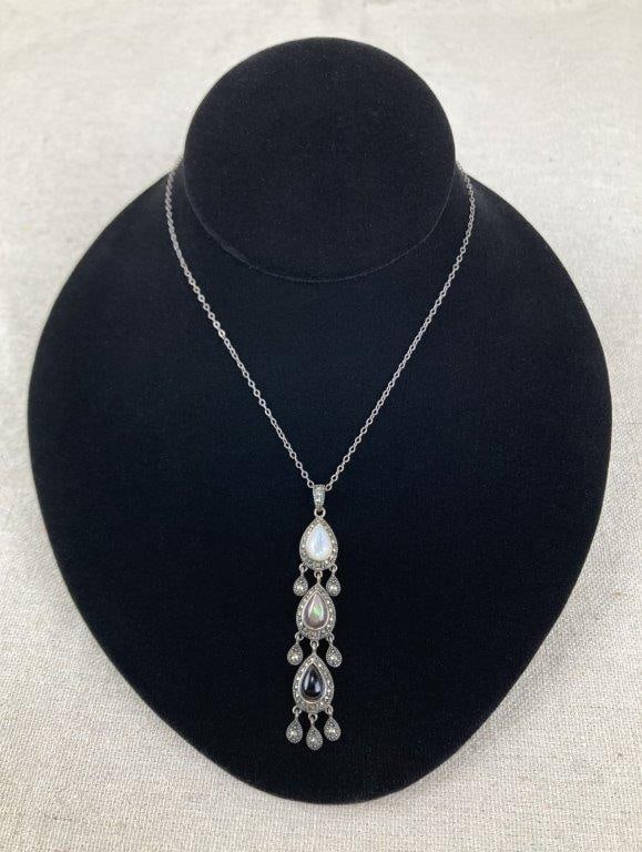 Vintage Art Deco Teardrop Necklace: Sterling silver necklace featuring three teardrop-shaped drops set with luminous mother of pearl and contrasting black onyx, accented by sparkling marcasite and additional dangling teardrop elements