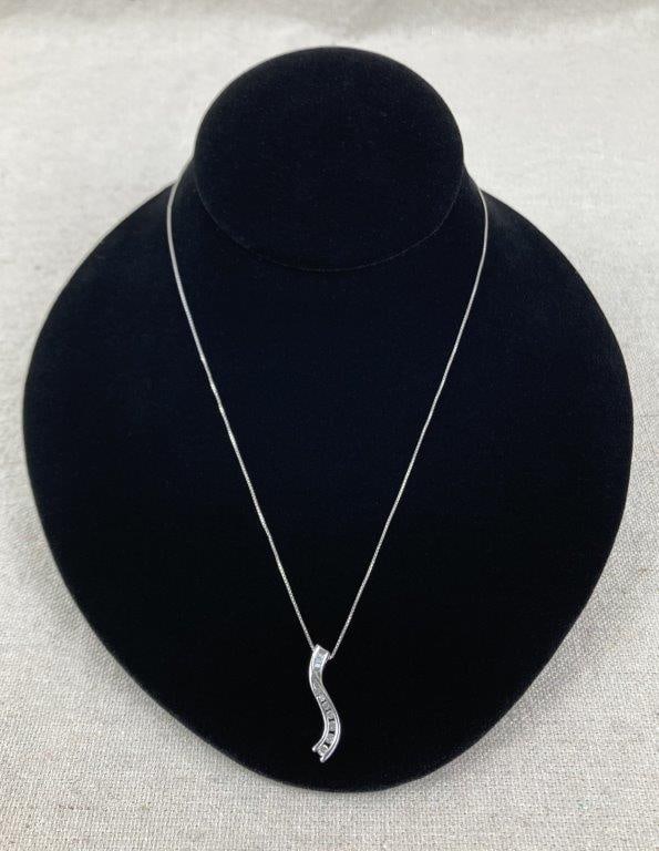 Vintage Sterling Silver Journey Necklace: Sterling silver necklace featuring an elegant S-curve pendant set with round and baguette-cut cubic zirconia stones, creating a refined, flowing design. Stamped JBDM 925 and suspended from a 23" box