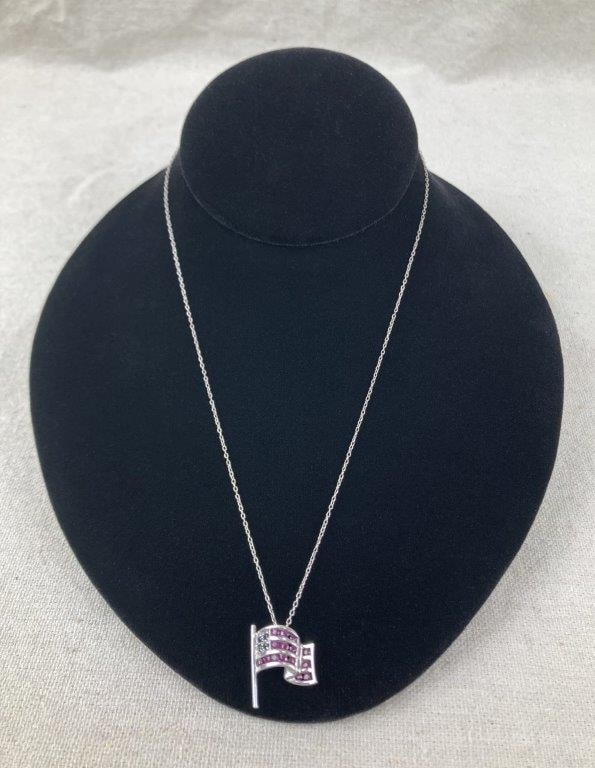 Sterling Silver American Flag Necklace: Sterling silver necklace featuring an American flag pendant set with blue and pink spinel stones for vibrant color and patriotic detail. The pendant is stamped 925 with a maker’s mark and is