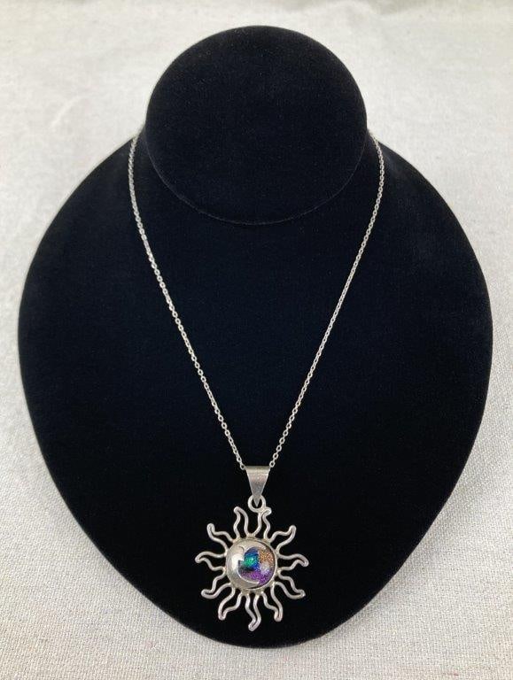 Artisan Sterling Silver Sun and Moon Necklace: Artisan-crafted sterling silver necklace made in Mexico, featuring a sun-and-moon motif centered by an iridescent art glass panel that displays vibrant color play. The pendant is marked Mexico and