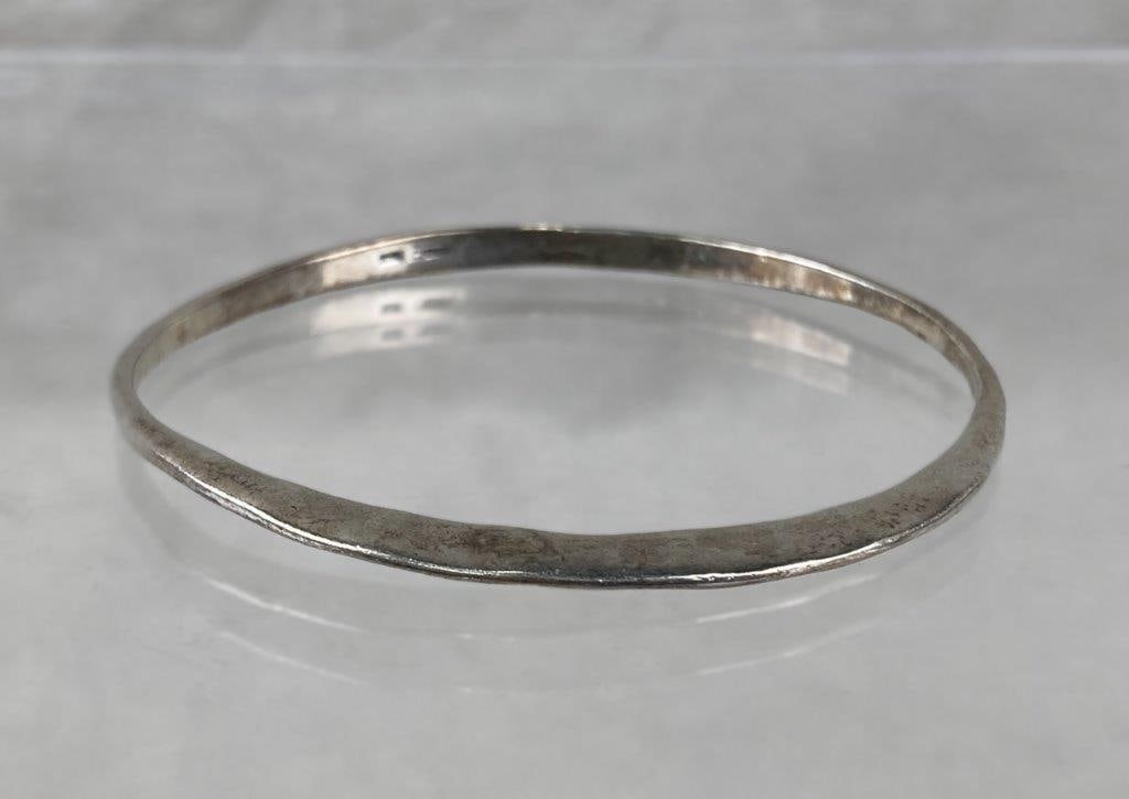 Robert Lee Morris Sterling Silver Bangle: Modern sterling silver bangle by Robert Lee Morris, featuring a softly hammered finish that highlights the sculptural, minimalist aesthetic for which the designer is known. Signed and marked on the in