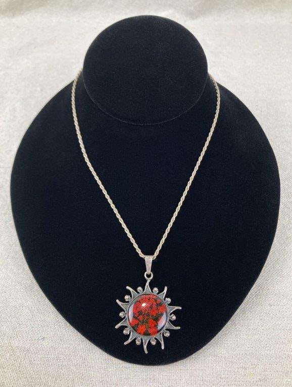 Artisan Sterling Silver Sun and Flower Necklace: Artisan-crafted sterling silver necklace featuring a radiant sun motif with finely worked rays, centered by a floral specimen encased in resin for a naturalistic accent. The reverse is marked 925 for