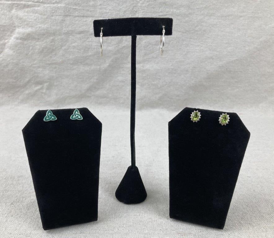 Three Pairs of Sterling Silver Earrings: Group of three pairs of sterling silver earrings, including a standout pair set with peridot stones surrounded by halos of clear, faceted accent stones. The peridot earrings measure approx. 3/8" H x