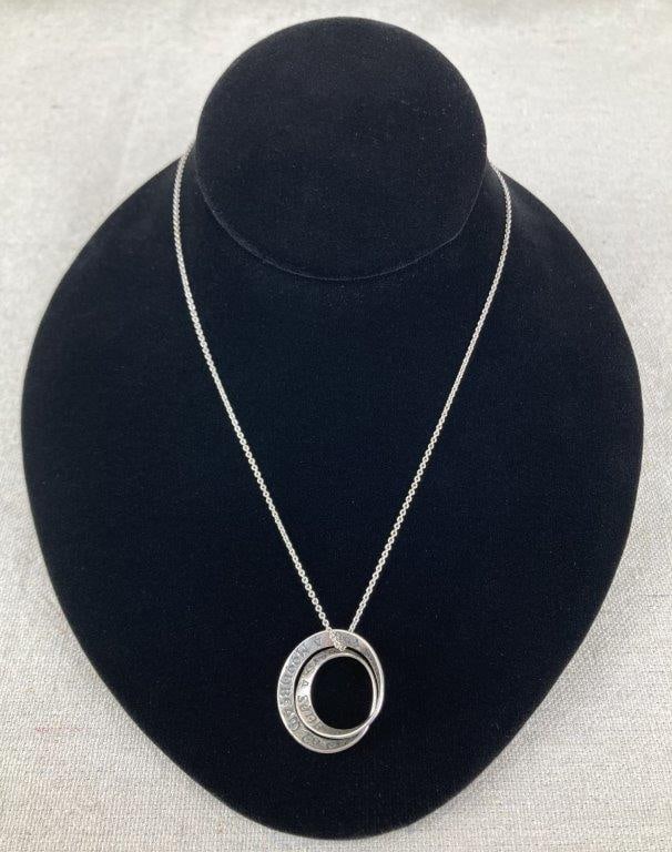 Sterling Silver Irish Blessing Necklace: Sterling silver necklace featuring a Möbius twist pendant engraved with the blessing, “May God grant you always, a sunbeam to warm you, a moonbeam to charm you, a sheltering angel so