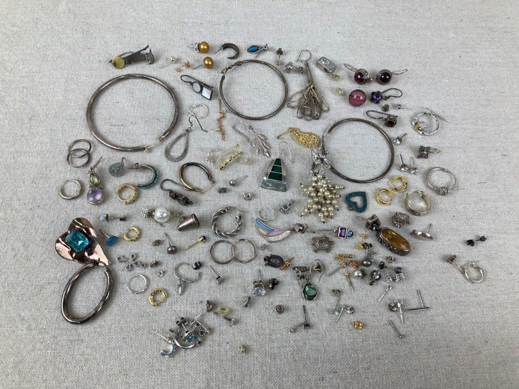 Lot of Sterling Silver Earrings: Assortment of sterling silver earrings including a fishhook pair with geometric malachite inlay stamped TN-47 925 (Taxco), a sterling silver wing earring accented with blue, yellow, pink, and clear