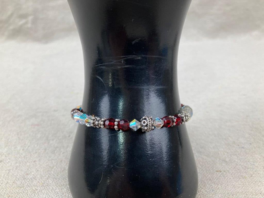 Sterling Silver Cancer Awareness Bracelet: Sterling silver cancer awareness bracelet by Sundance Jewelry Company featuring red and clear beads symbolizing head and neck cancers, accented with decorative silver spacer beads, a small ribbon