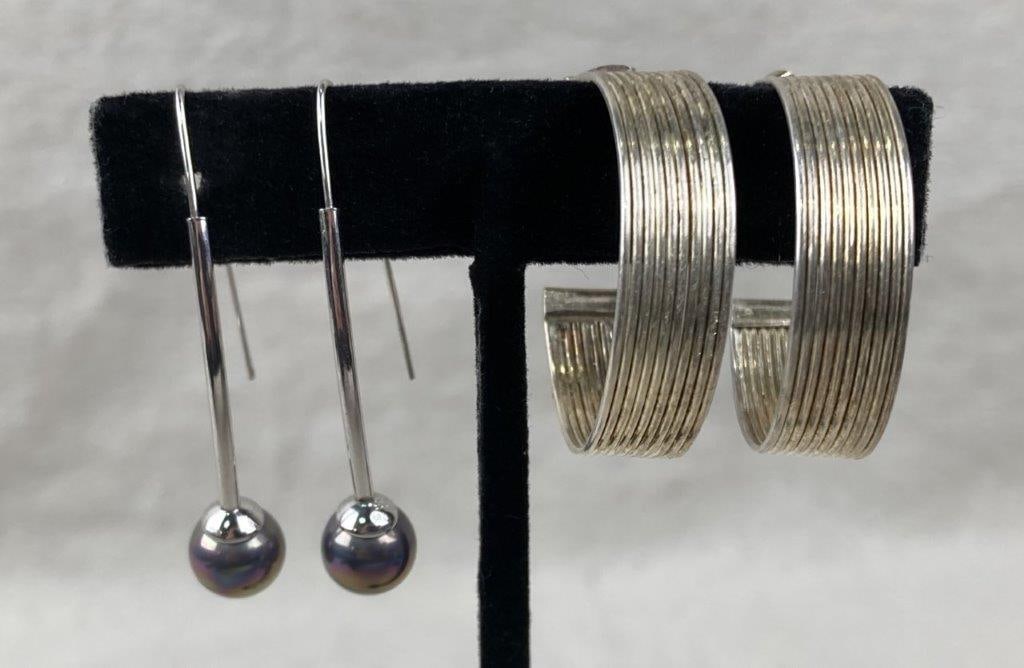 Cultured Black Pearl and Hoop Sterling Silver Earrings: Pairing of two sterling silver earring sets including hook earrings with cultured black pearls displaying vibrant iridescent coloration, stamped 925, and a pair of multi-strand wire hoop earrings