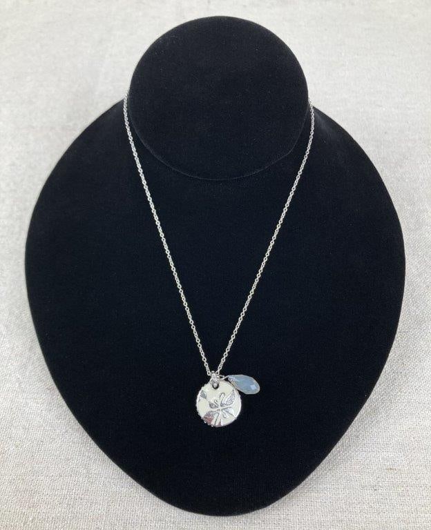 Vintage Swarovski Medallion Necklace: Silver-tone necklace by Swarovski featuring a round medallion pendant set with clear crystals, with one side finished in white enamel patterned with the iconic Swarovski swan logo in varying sizes