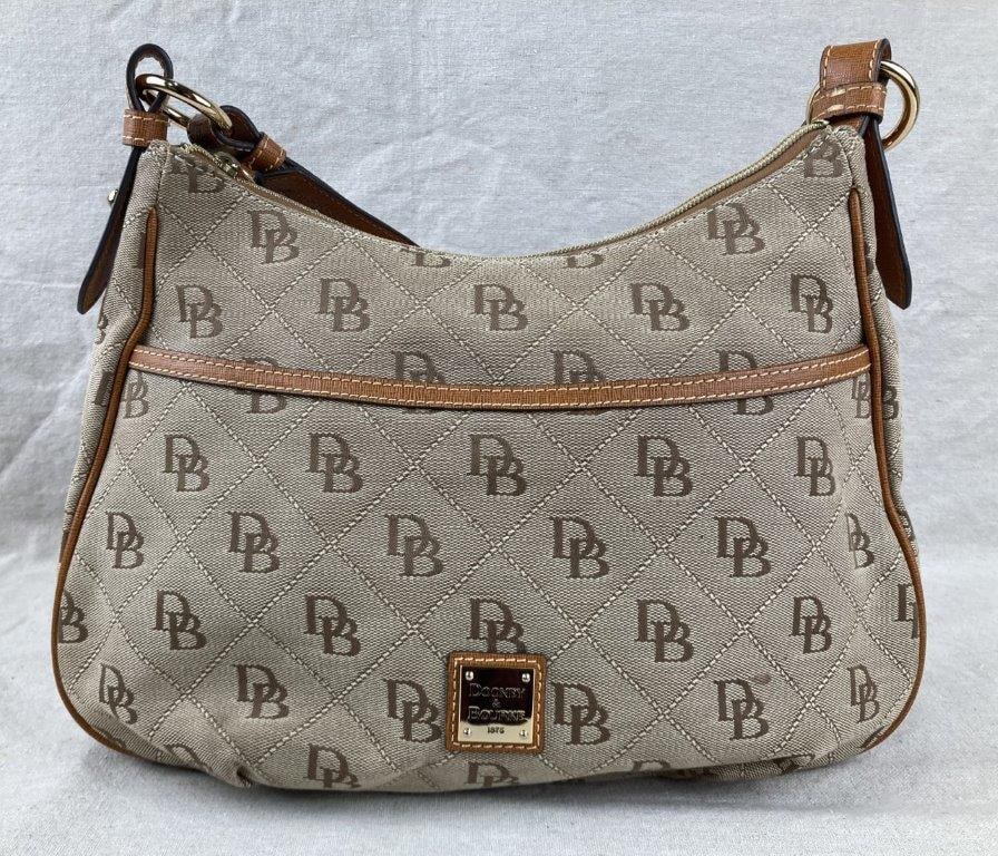 Vintage Dooney & Bourke Maxi Quilt East West Shoulder Bag: Dooney & Bourke shoulder bag featuring a quilted exterior in coated cotton canvas with the signature DB monogram pattern, accented by tan leather trim and gold-tone hardware. Designed with an