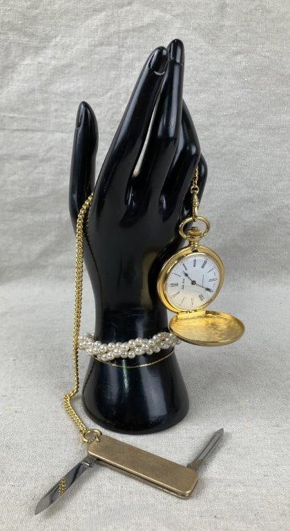 Vintage Belle Luisse Goldtone Pocket Watch with Accessories: Vintage goldtone pocket watch by Belle Luisse, Swiss made. The watch is accompanied by a faux pearl Albert-style chain and a small pocket knife accessory. The pocket watch case measures approx. 2" in