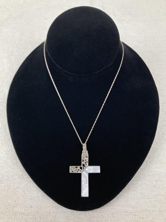 Sterling Silver and Mother-of-Pearl Cross Necklace: Sterling silver necklace featuring a mother-of-pearl inlay cross pendant adorned with reticulated filigree and marcasite accents. The cross is unmarked for silver content but tested as sterling; the c