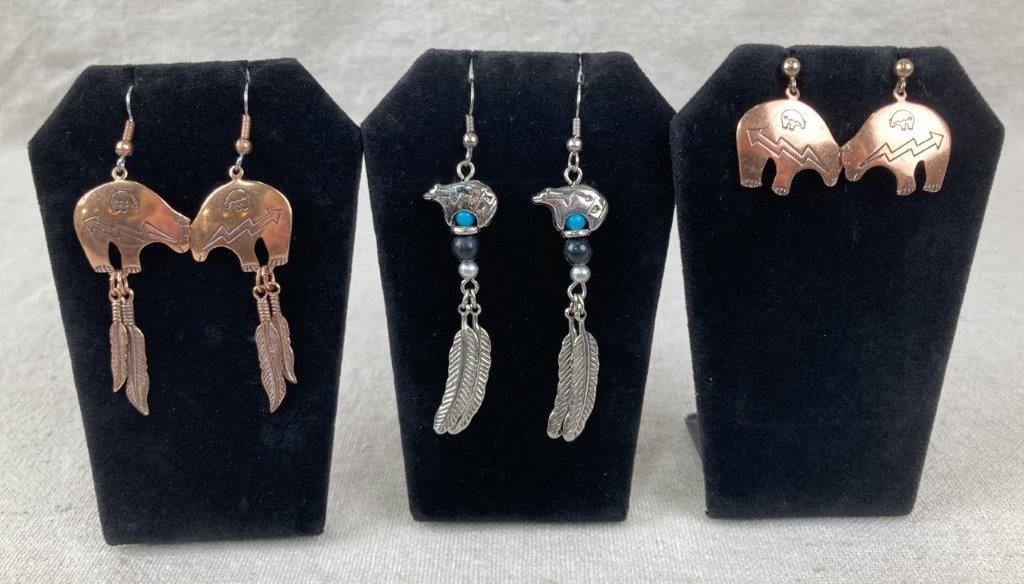 Three Southwestern-Style Bear Earrings: Group of three Southwestern-style dangle earrings, each displaying Native American–inspired designs with heartline bear motifs. Two examples feature copper-tone metal, and one is rendered in