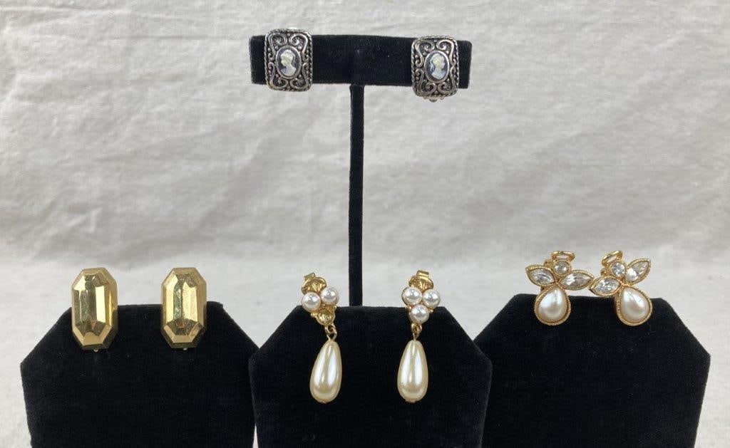 Four Vintage Costume Earring Assortment: Four-piece assortment of vintage earrings. The standout pair is rendered in silvertone and features a central cameo framed by intricate scrollwork within a square setting, in clip-on form. Two