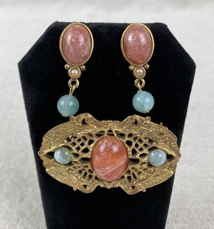 Vintage Goldtone Costume Jewelry Pair: Vintage costume jewelry pair featuring coordinated goldtone settings. The brooch displays reticulated filigree in an antique-inspired style, centered by a rose-pink marble-effect stone and accented