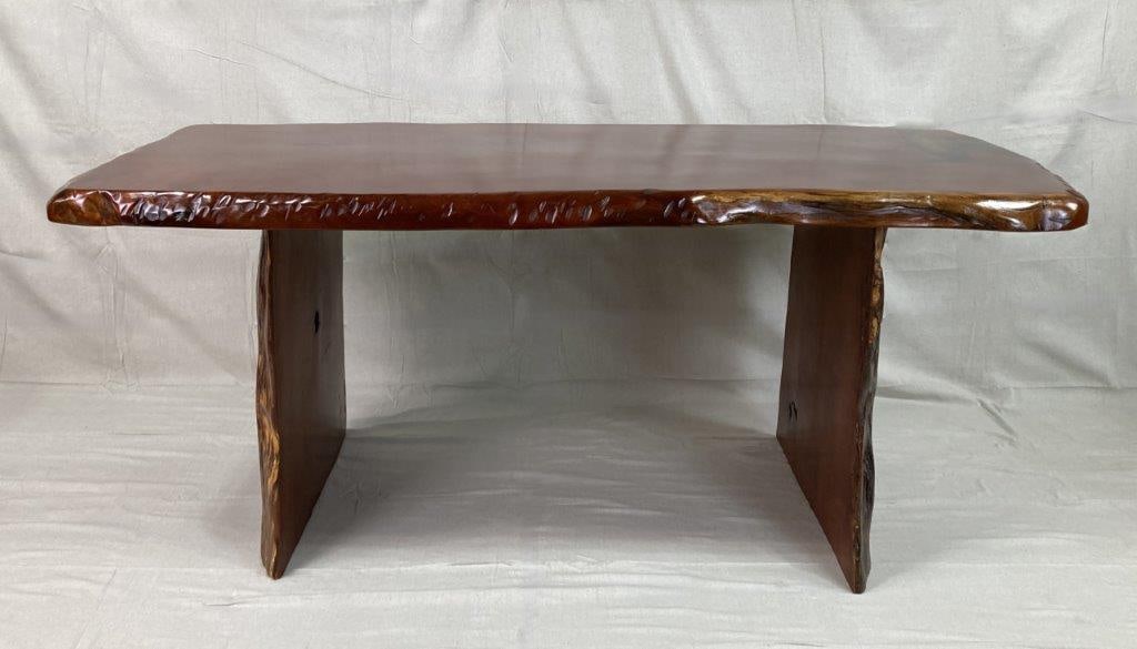 Live Edge Cherry Dining Table: A live-edge solid cherry dining table of free-form design, retaining the natural contour and bark texture along the edges. The top features inlaid resin accents, and the legs are crafted from natural