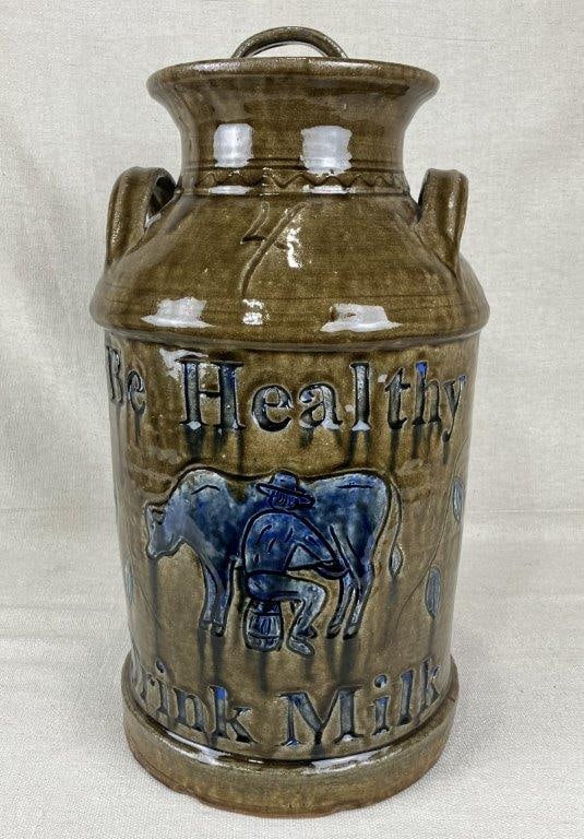 Clint Alderman Southern Stoneware Four Gallon Jug: A Clint Alderman alkaline glaze stoneware milk jug of straight-sided cylindrical form with applied handles, featuring an incised scene of a man milking a cow alongside the phrase “Be Healthy Dri