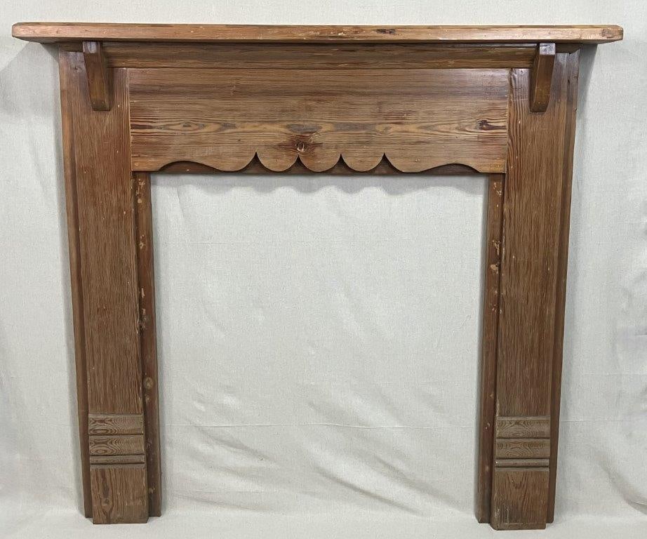 Southern Pine Fireplace Mantel: A solid Southern pine fireplace mantel featuring scalloped decoration along the header and horizontal fluting on the plinths. Measures approximately 50 1/2″ H x 52 1/2″ W x 7 3/4″