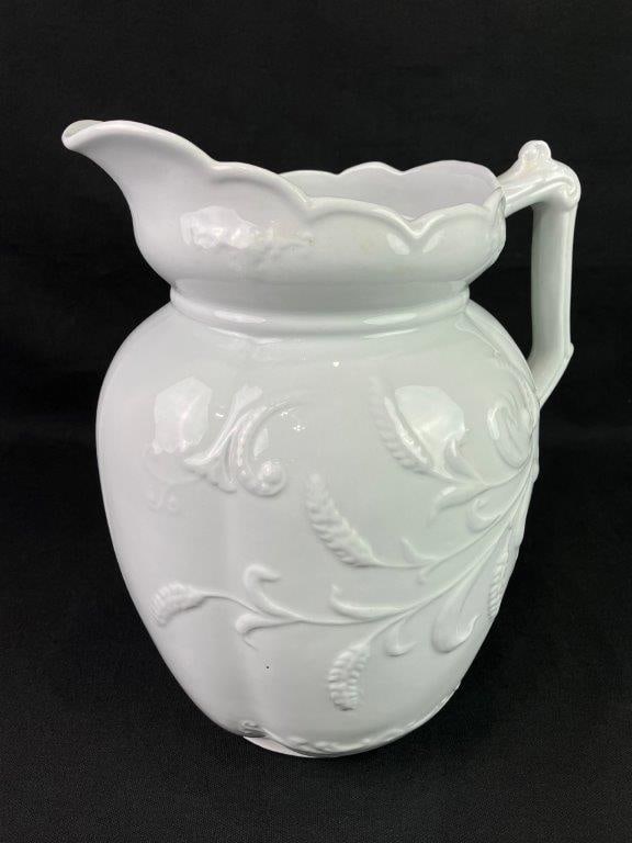 English Ironstone Pitcher: A 19th century English ironstone pitcher by Bishop & Stonier, featuring an embossed wheat pattern in relief around the body. The classic form and sturdy construction reflect traditional Victorian-era