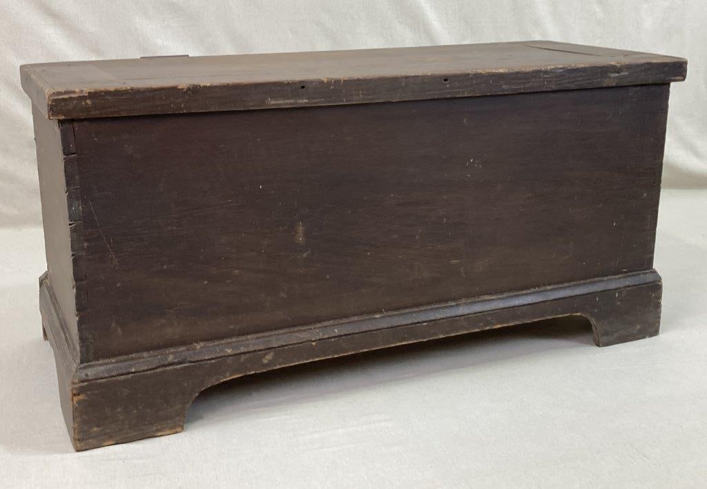 19th Century Southern Painted Blanket Chest: A 19th century Southern painted blanket chest in brown, featuring a hinged lid above a dovetailed case construction. The surface retains a worn, aged patina that reflects its utilitarian history and
