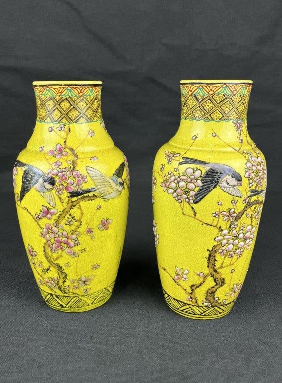 Pair of Signed Chinese Famille Jaune Enameled Porcelain Vases: A pair of Chinese famille jaune enameled porcelain vases with a brilliant yellow ground, finely decorated with birds and cherry blossoms. Both are signed, translating to “made by Seiko
