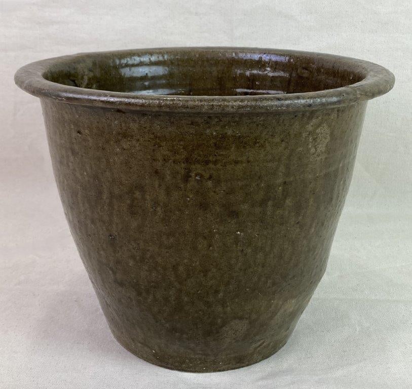 Southern Alkaline Glaze Cream Riser: A Southern stoneware cream riser finished in a rich, runny alkaline glaze, exhibiting characteristic surface variation from the firing process. Measures approximately 9″ H x 11 1/2″ in