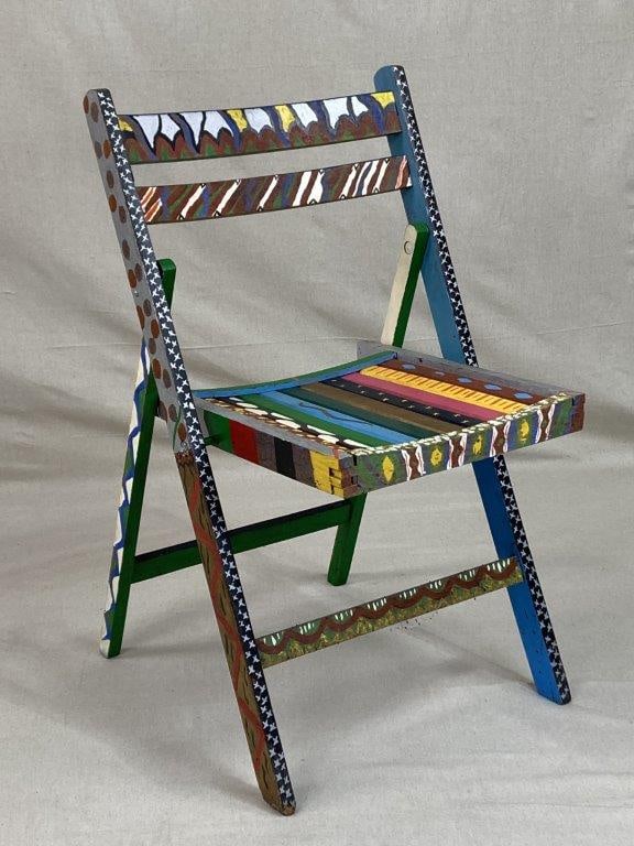 Folk Art Painted Folding Chair: A folk art painted folding chair decorated in vibrant multi colored tones, showcasing expressive hand-applied design and individual artistic character. The classic folding form is enhanced by the