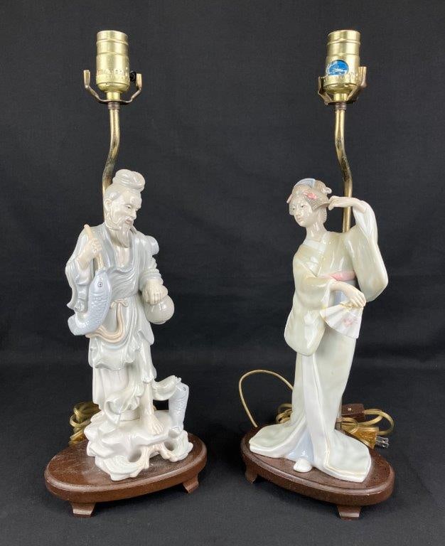 Two Japanese Porcelain Figural Lamps: A pair of Japanese porcelain figural lamps, one depicting a fisherman holding a koi fish and the other portraying a woman in elegant attire with styled coiffure, captured in an active pose while