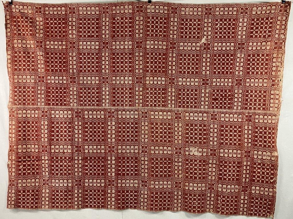 19th Century Overshot Coverlet: A 19th century American overshot coverlet woven in a pleasing two-color palette of tan and red, featuring alternating patterned panels joined at the center seam. Measures approximately