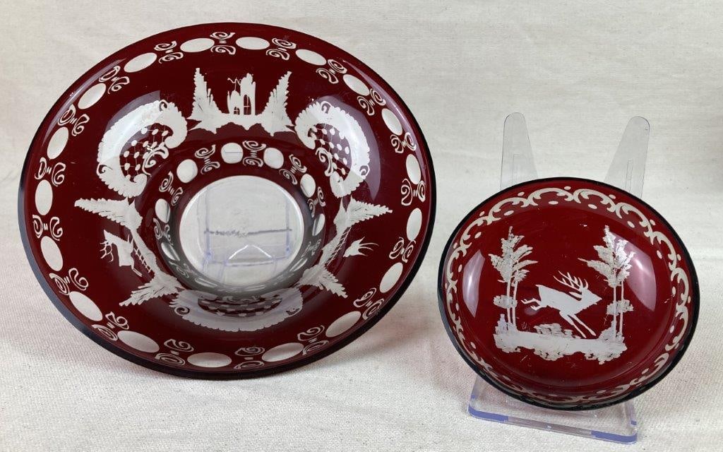 Vintage Egerman Bohemian Ruby Red Glass Bowls: A pair of Bohemian ruby red cut-to-clear glass bowls by Egermann, including one larger, deeper example and one smaller bowl. Both feature etched decoration depicting a running deer, with the larger bo